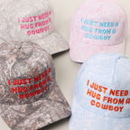 I JUST NEED A HUG FROM A COWBOY Embroidered Camo Trucker Hat