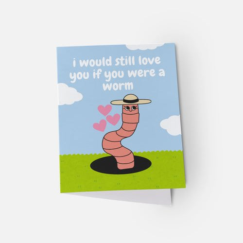 Card with a cartoon worm wearing a hat and sunglasses, surrounded by hearts, on a blue sky and green ground background.